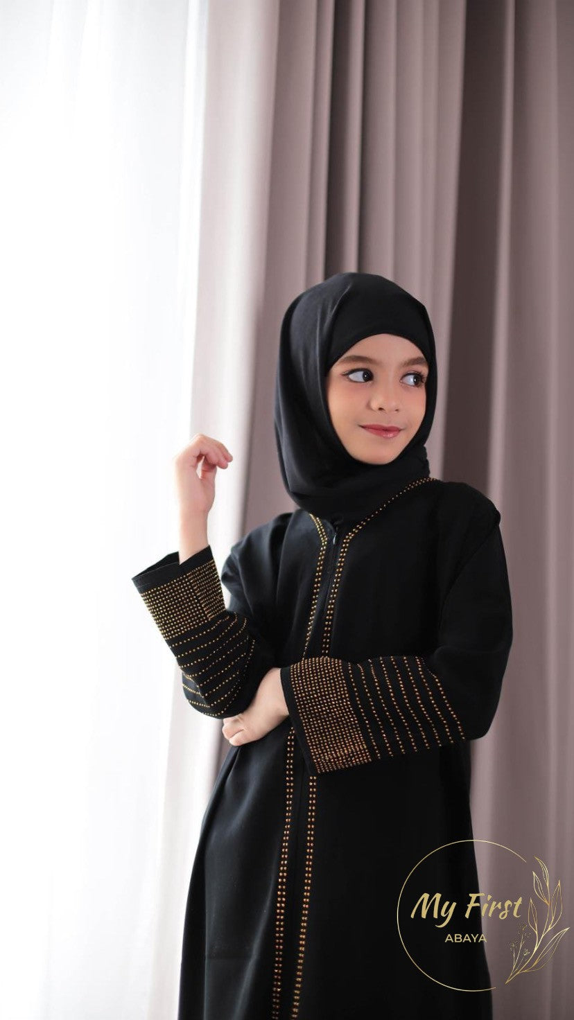 The Hawwa abaya. Modest black girls abaya with Swarovski rhinestones throughout the dress. Sizes available for young girls ages 4 to 12 years old.
