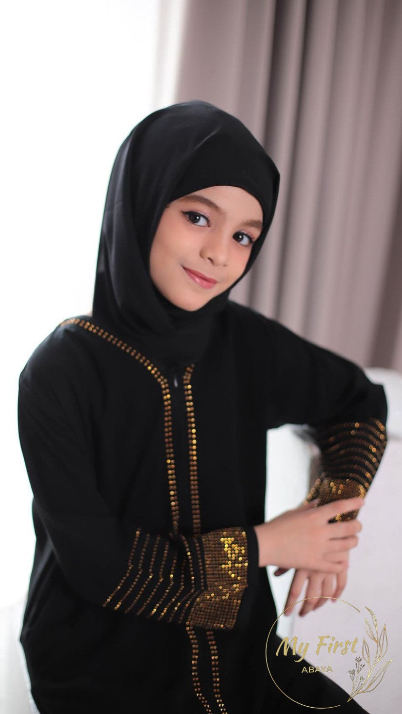 The Hawwa abaya. Modest black girls abaya with Swarovski rhinestones throughout the dress. Sizes available for young girls ages 4 to 12 years old.